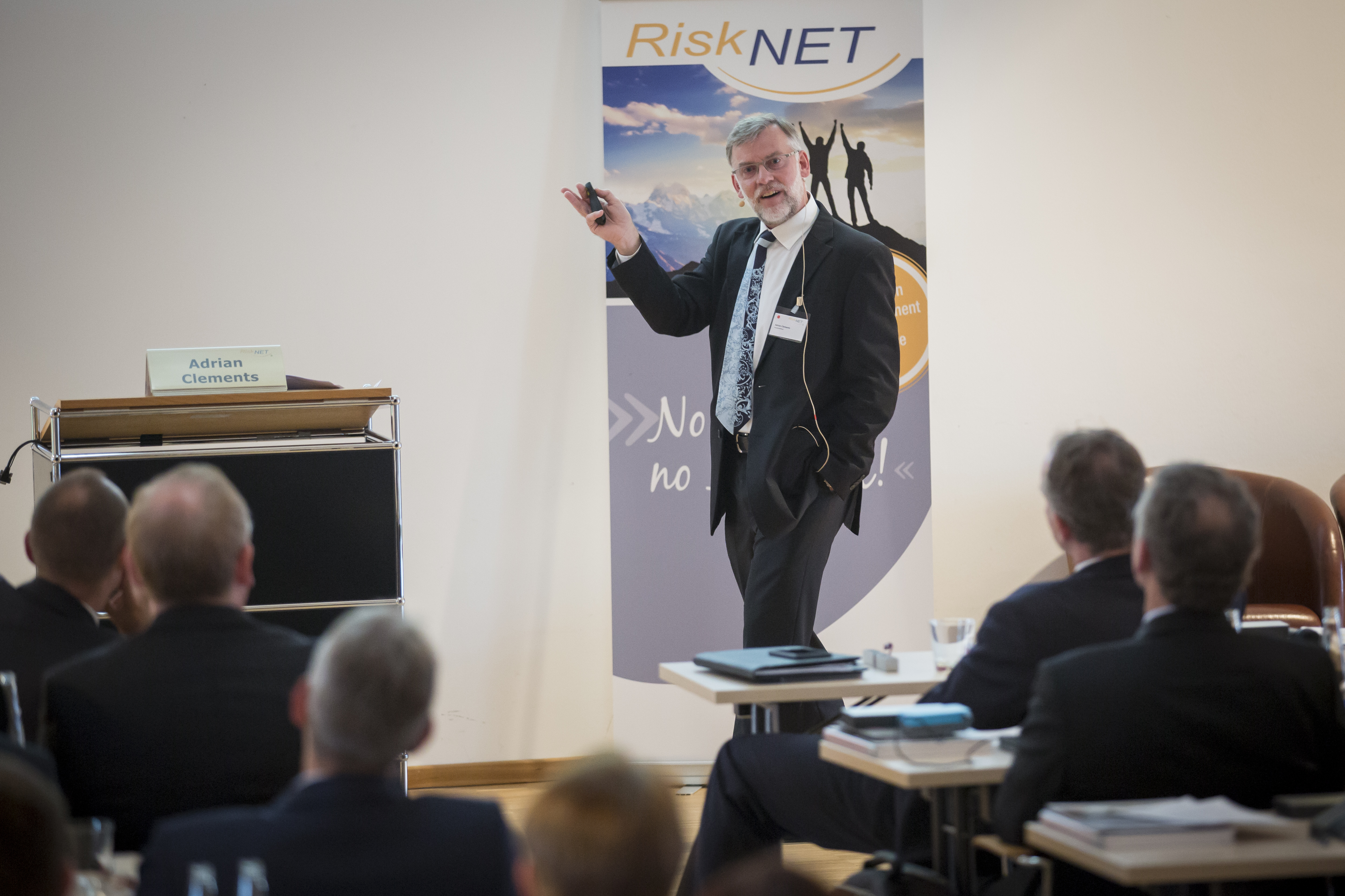 Adrian Clements speaking in a professional setting